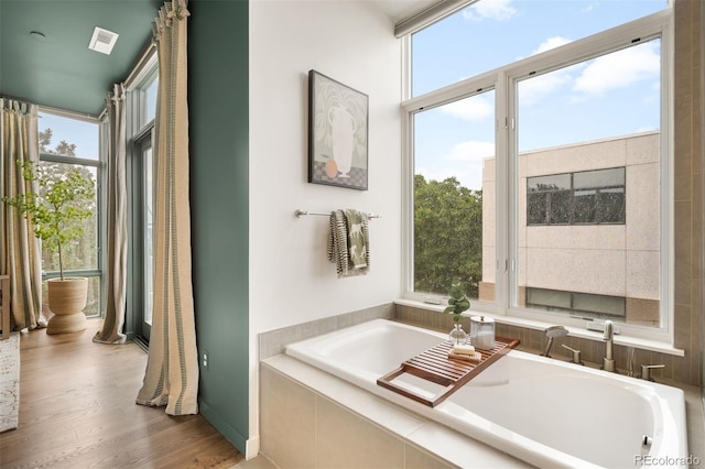 3220 Zuni St, Denver, CO 80211 - full bath featuring healthy amount of natural light, a bath, and wood finished floors