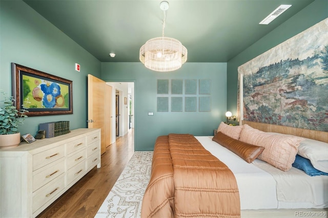 3220 Zuni St, Denver, CO 80211 - bedroom featuring a chandelier and dark wood-type flooring