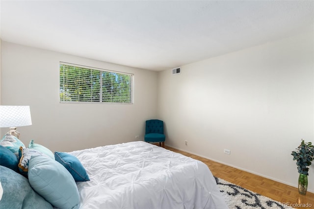 bedroom with light parquet flooring