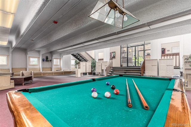 rec room featuring a textured ceiling, pool table, and light carpet