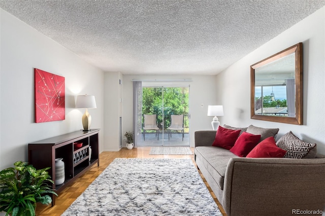 living room with light parquet flooring and a textured ceiling