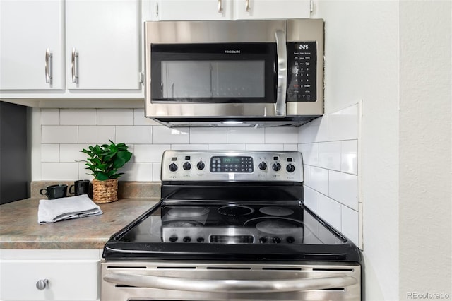 kitchen with white cabinetry, stainless steel appliances, and decorative backsplash