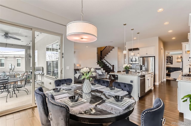 dining space with ceiling fan and dark hardwood / wood-style floors