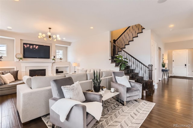 living room with a notable chandelier and dark hardwood / wood-style flooring