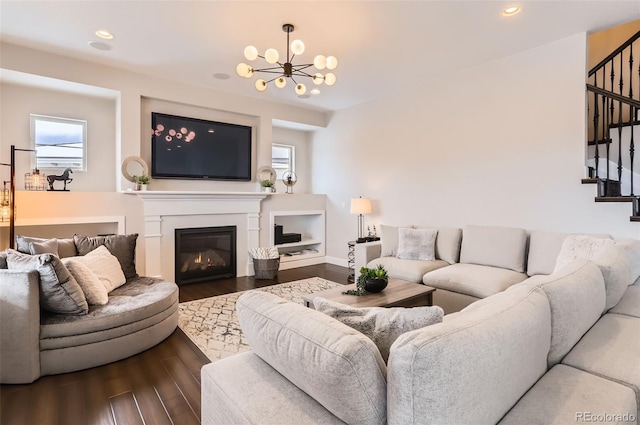 living room featuring an inviting chandelier and dark hardwood / wood-style floors