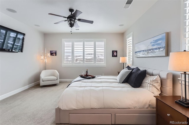 bedroom with ceiling fan and light carpet