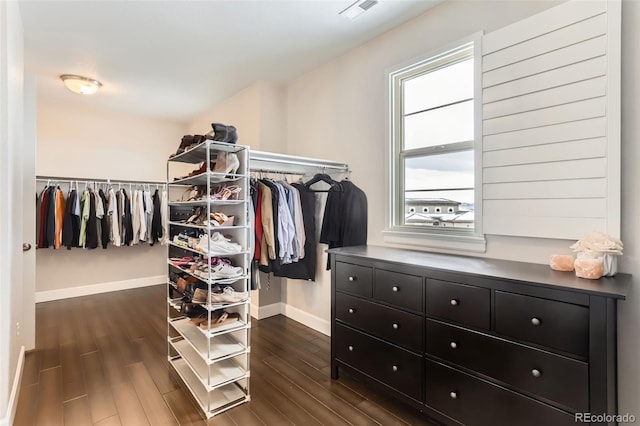 walk in closet with dark hardwood / wood-style floors