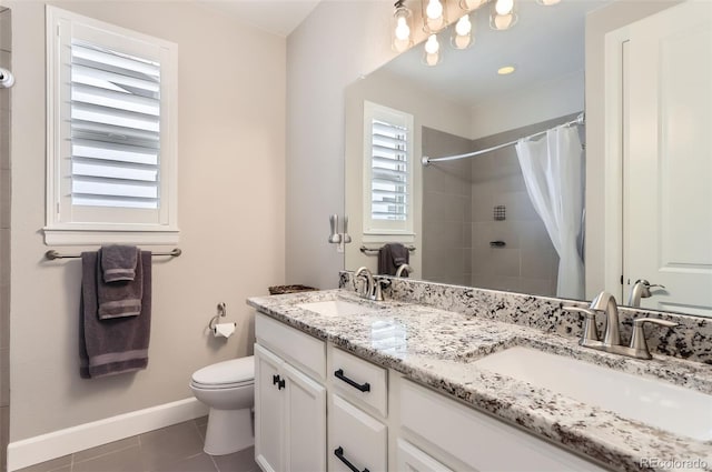 bathroom featuring vanity, curtained shower, a healthy amount of sunlight, and tile patterned floors