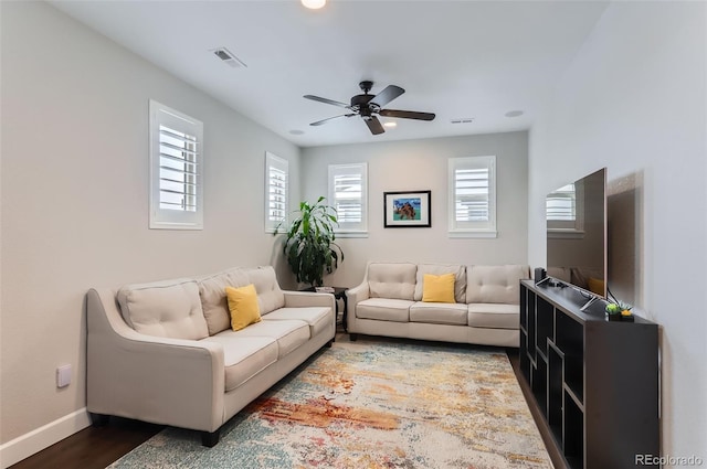 living room with hardwood / wood-style flooring and ceiling fan