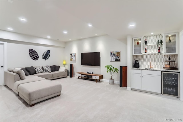 living room featuring light colored carpet, beverage cooler, and indoor wet bar