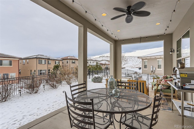 snow covered patio featuring ceiling fan