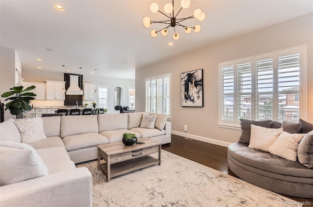 living room with dark wood-style floors, baseboards, a chandelier, and recessed lighting