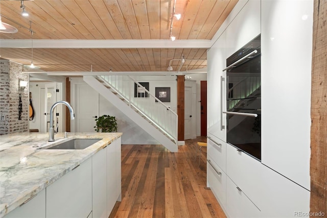 kitchen featuring wood ceiling, white cabinetry, and hardwood / wood-style flooring