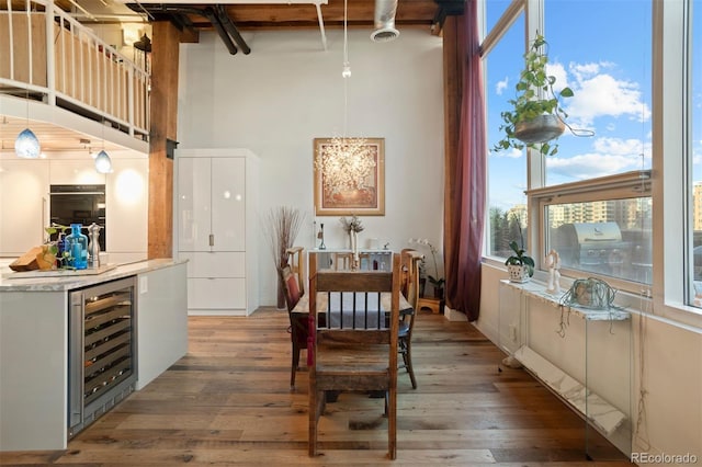 dining room featuring beverage cooler and hardwood / wood-style floors