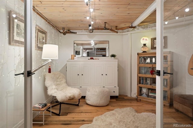 living area featuring wooden ceiling and wood-type flooring