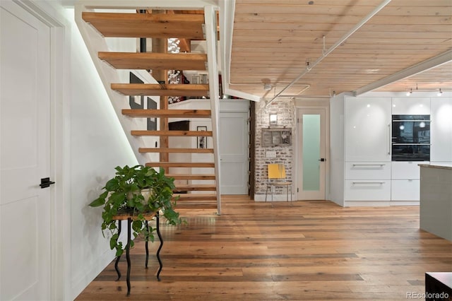 interior space with hardwood / wood-style flooring and wood ceiling