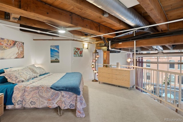 bedroom with carpet floors and beamed ceiling