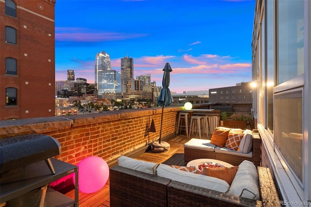 balcony at dusk featuring outdoor lounge area