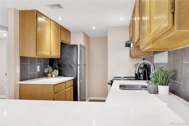 5955 E 10th Ave Unit 201, Denver, CO 80220 - kitchen featuring light countertops, backsplash, freestanding refrigerator, exhaust hood, and white range