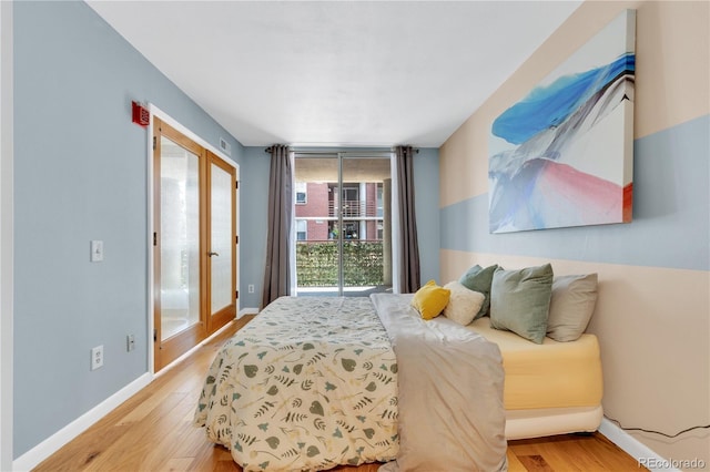 5955 E 10th Ave Unit 201, Denver, CO 80220 - bedroom with light wood-style floors and access to exterior