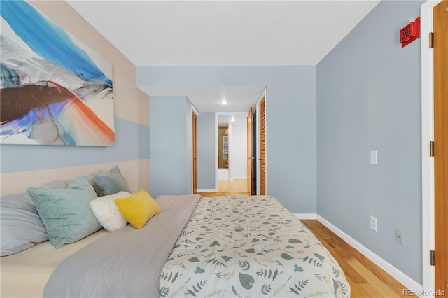 5955 E 10th Ave Unit 201, Denver, CO 80220 - bedroom featuring wood finished floors, a closet, and recessed lighting
