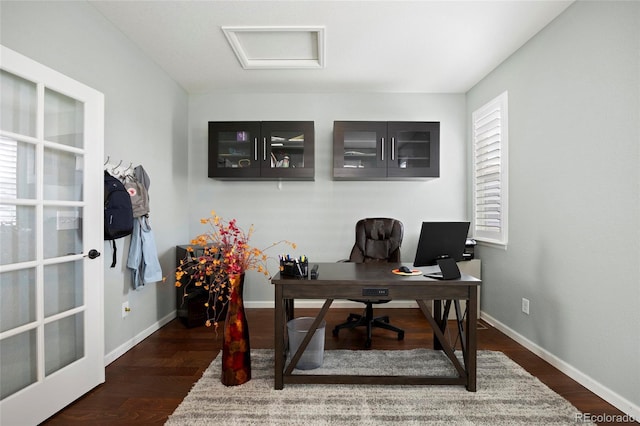 office area with attic access, baseboards, and wood finished floors