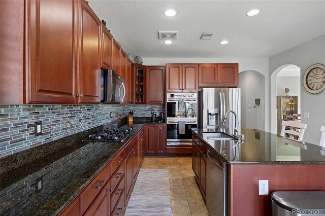 kitchen featuring a sink, visible vents, backsplash, and appliances with stainless steel finishes