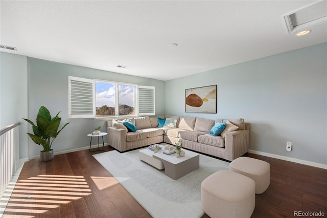 living area featuring baseboards, visible vents, and wood-type flooring