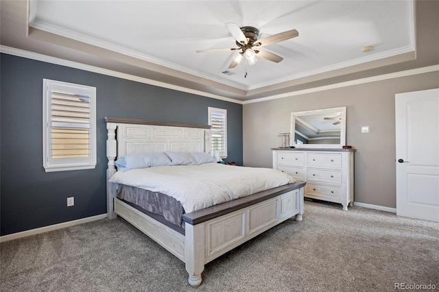 bedroom with light colored carpet, a raised ceiling, and baseboards