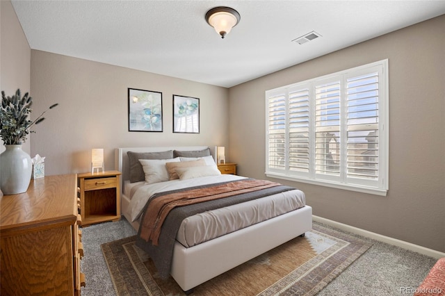 bedroom featuring carpet, visible vents, and baseboards