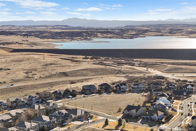 drone / aerial view with a residential view and a water and mountain view