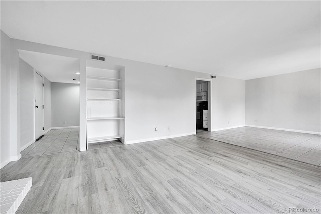9700 E Iliff Ave Unit D44, Denver, CO 80231 - unfurnished room with light wood finished floors, baseboards, and built in shelves