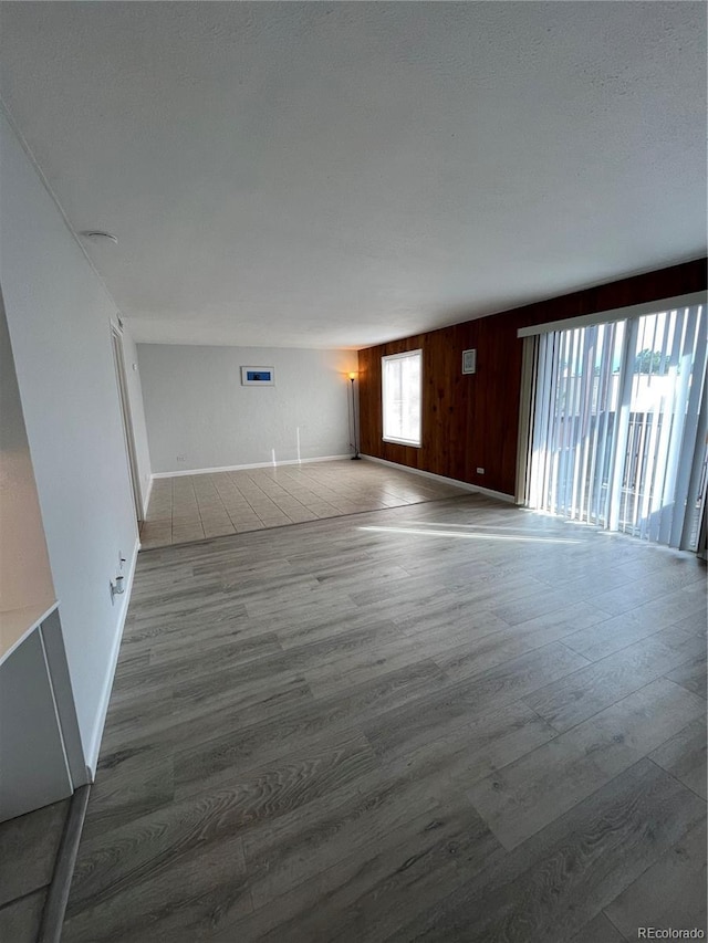 9700 E Iliff Ave Unit D44, Denver, CO 80231 - spare room with wood finished floors, baseboards, and wood walls