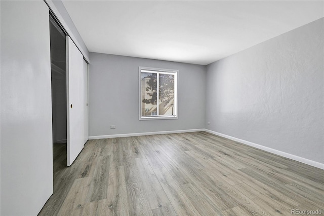 9700 E Iliff Ave Unit D44, Denver, CO 80231 - unfurnished bedroom with light wood-style flooring, baseboards, and a closet