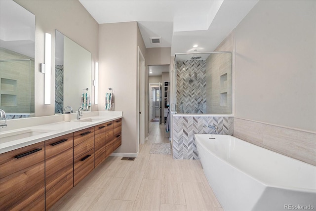 bathroom with vanity, tile walls, and shower with separate bathtub