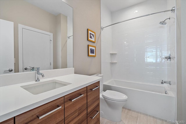 full bathroom featuring tile patterned floors, tiled shower / bath combo, vanity, and toilet