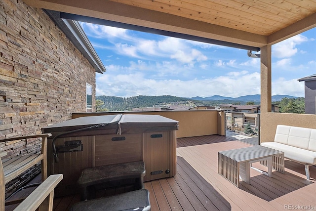 deck featuring a mountain view and a hot tub