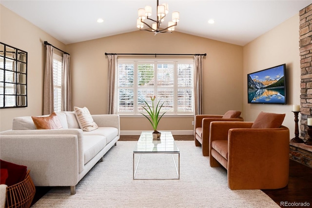 living room featuring vaulted ceiling, wood-type flooring, a wealth of natural light, and a notable chandelier