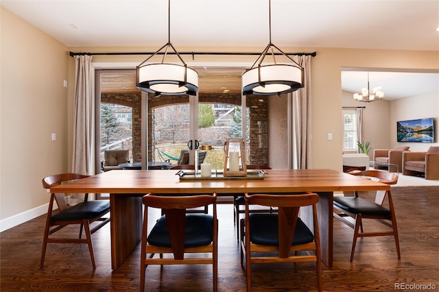 dining area featuring a healthy amount of sunlight and dark hardwood / wood-style flooring