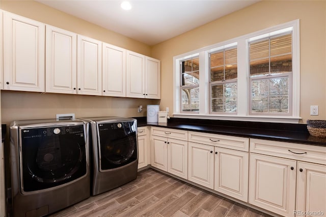 washroom with cabinets, hardwood / wood-style flooring, and independent washer and dryer