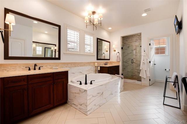 bathroom with vanity, parquet floors, a notable chandelier, and shower with separate bathtub