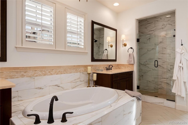 bathroom with vanity and independent shower and bath