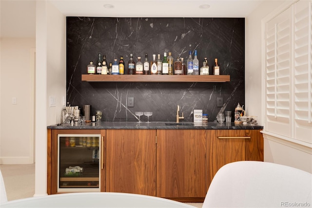 bar featuring wine cooler, sink, and decorative backsplash