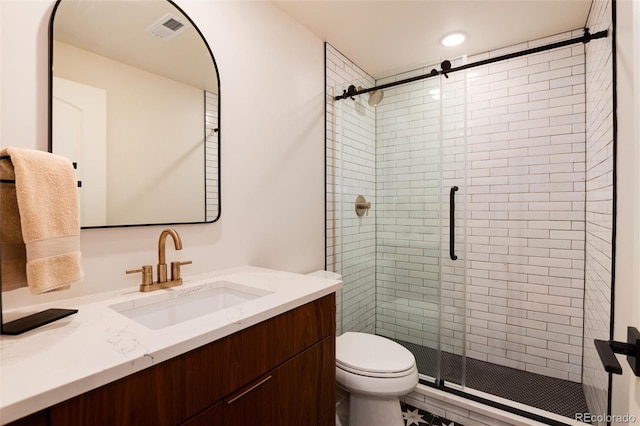 bathroom with vanity, toilet, and walk in shower