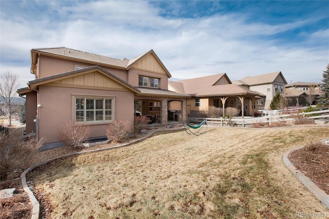 rear view of property with a lawn