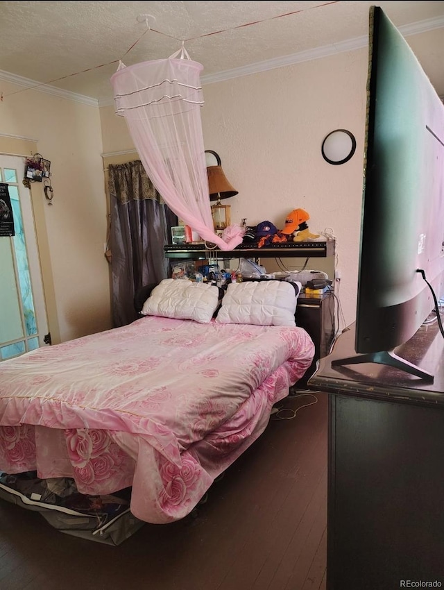 bedroom with hardwood / wood-style flooring and ornamental molding