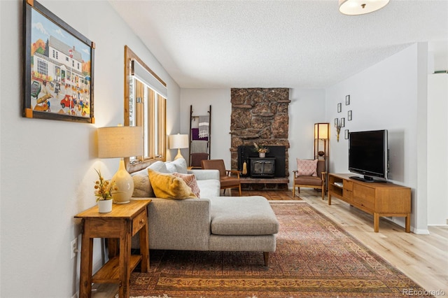 living room featuring a textured ceiling and wood finished floors