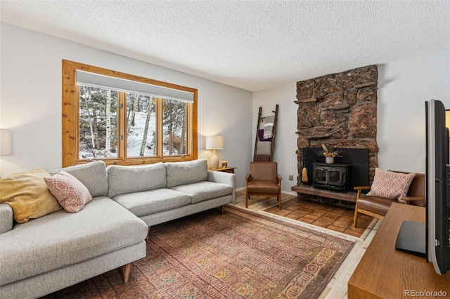 living area featuring a textured ceiling and a wood stove