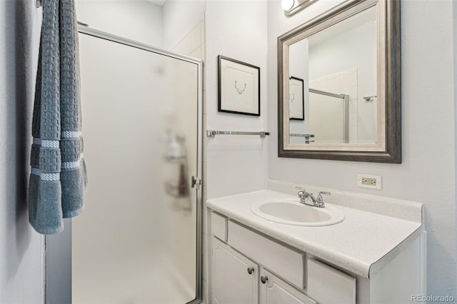 bathroom with a shower stall and vanity