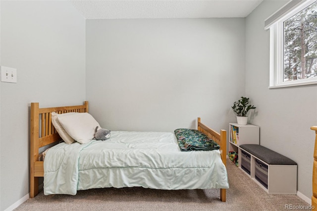 bedroom with baseboards and carpet floors